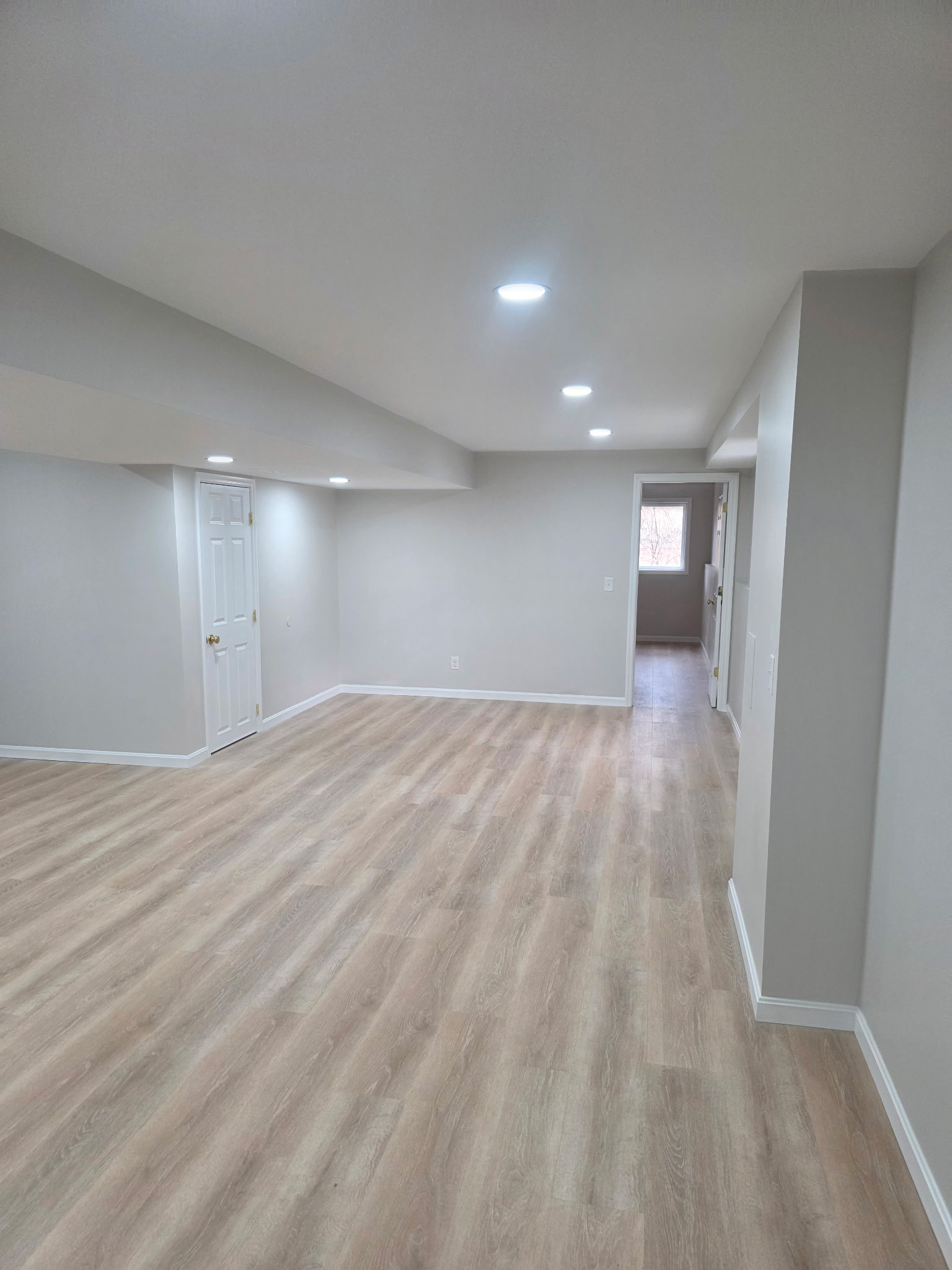 Finished basement remodeling project with drywall, flooring, trim, paint, and finished living space by Alabaster Contracting Solutions in Greater Cincinnati and Southwest Ohio.